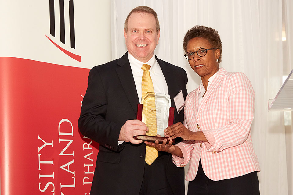 Dr. David Yoder poses with Dean Natalie Eddington after receiving the Key to Pharmacy Hall.