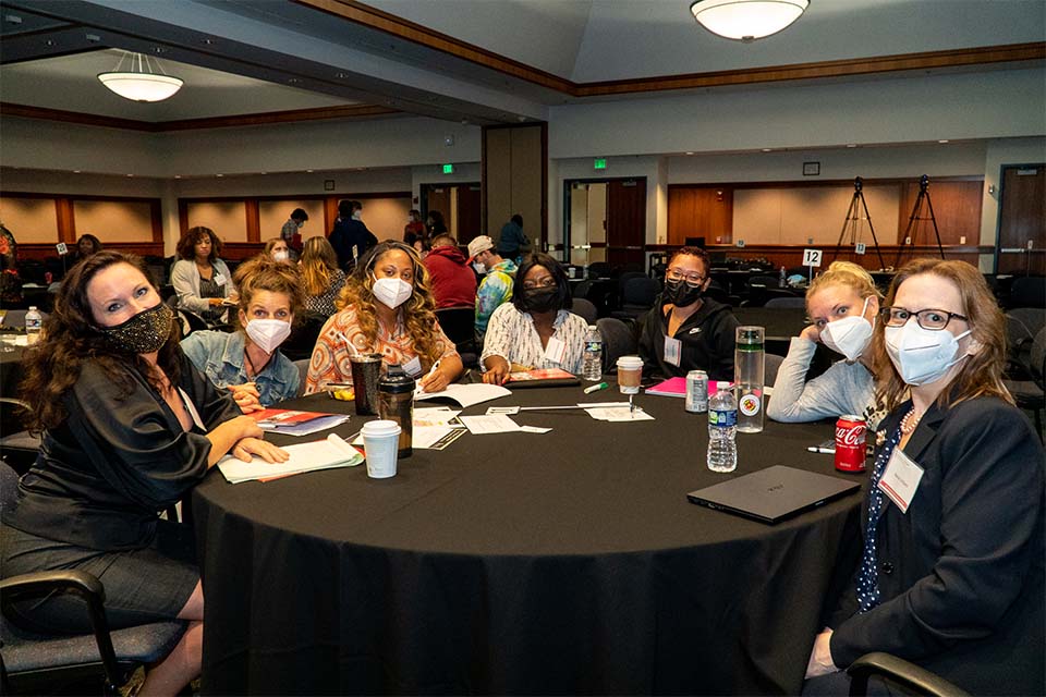 a group of people sitting near black round table