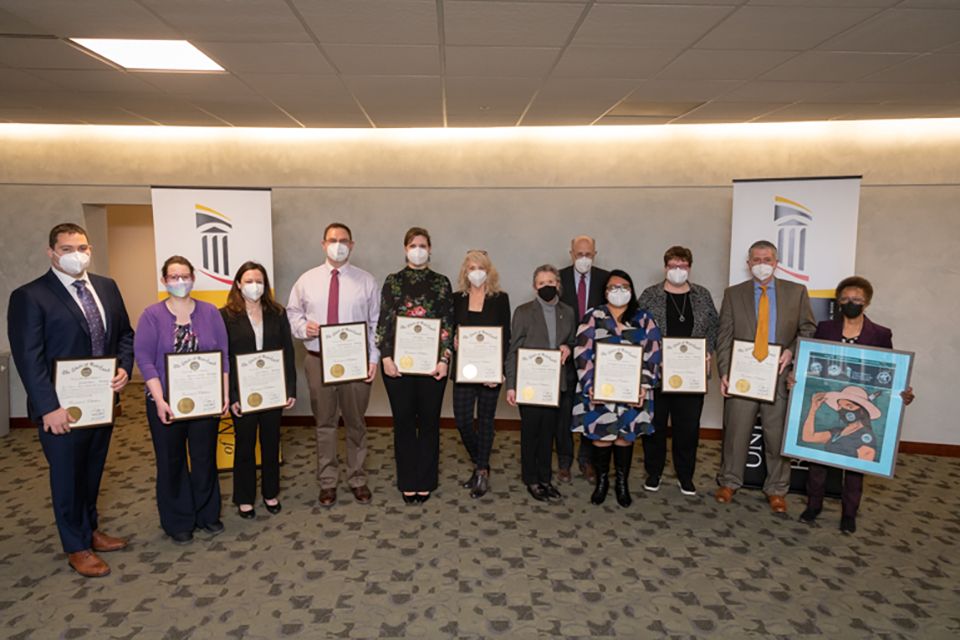 A group poses holding certificates.