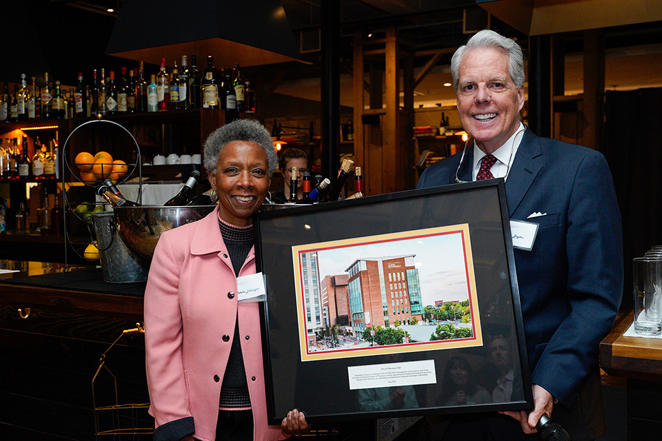 Dean Eddington receives the Key to Pharmacy Hall award from Ken Boyden